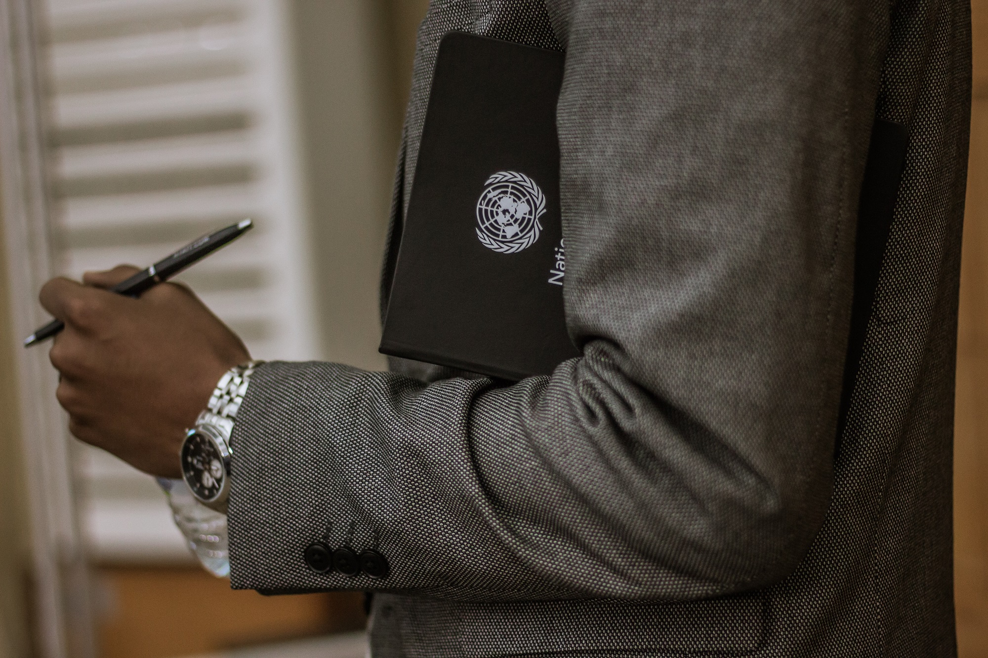 Man holding UN notebook