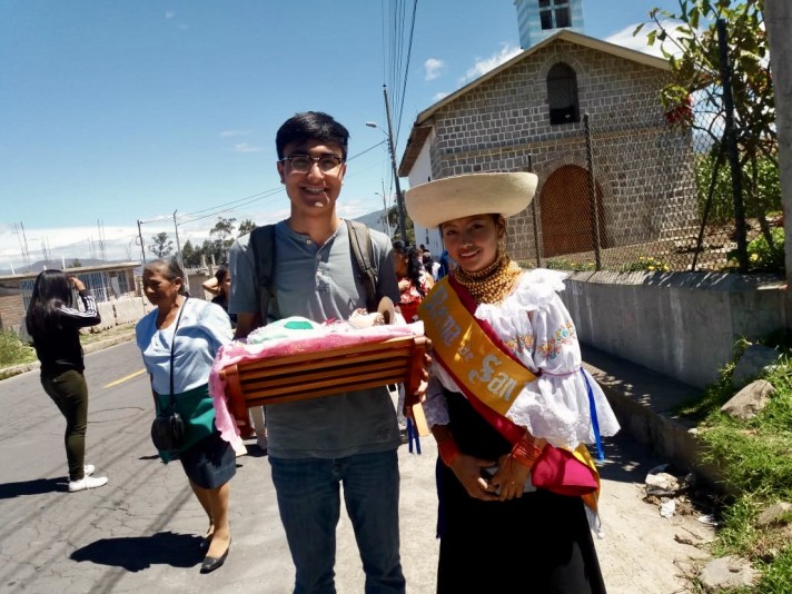 Jeffrey in a procession with a member of his host family in Ecuador